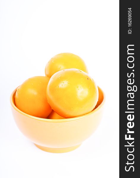 yellow and fresh tomatos in the yelloy bowl