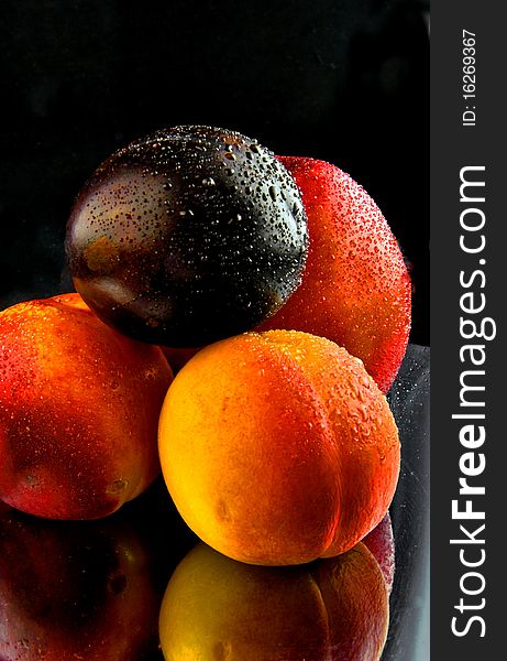 Peaches, are perfused by the water, removed on a black background. Peaches, are perfused by the water, removed on a black background