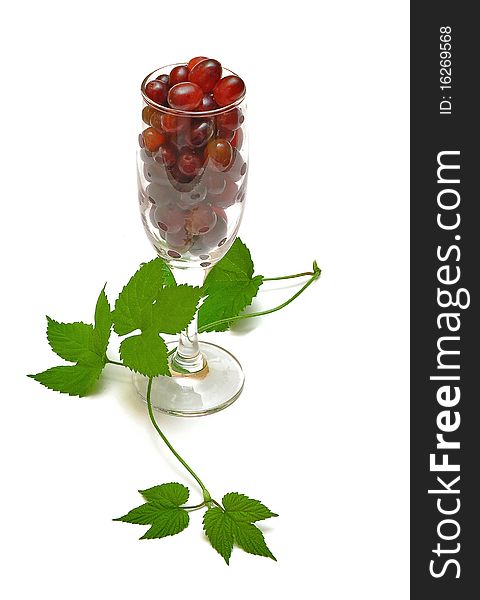 Red grapes and glass isolate on white