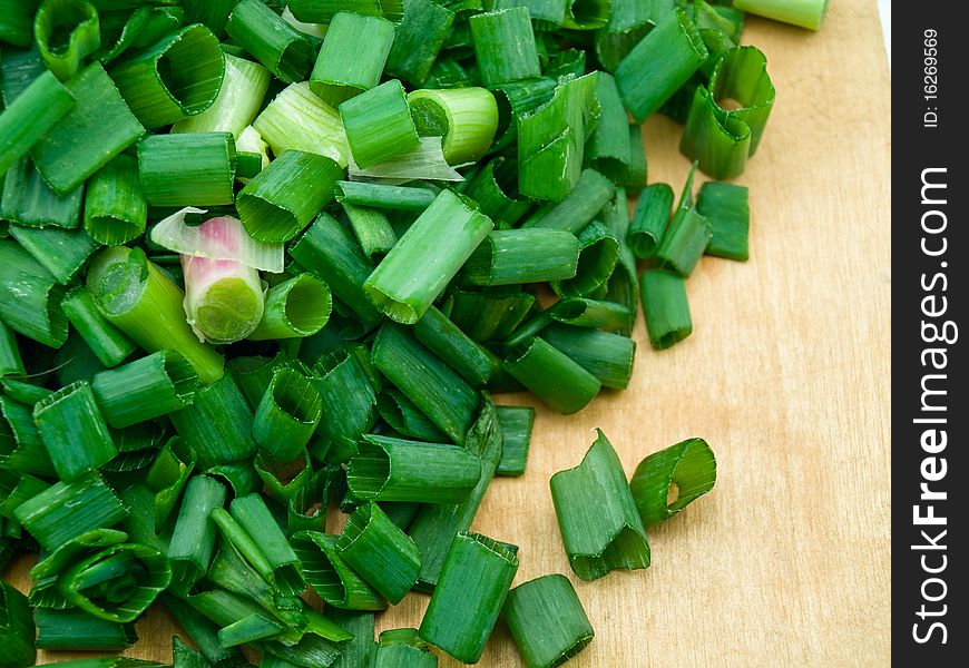 The green onions are cut on a kitchen board