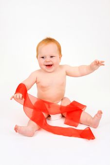 The Child Playing With A Red Ribbon Royalty Free Stock Images