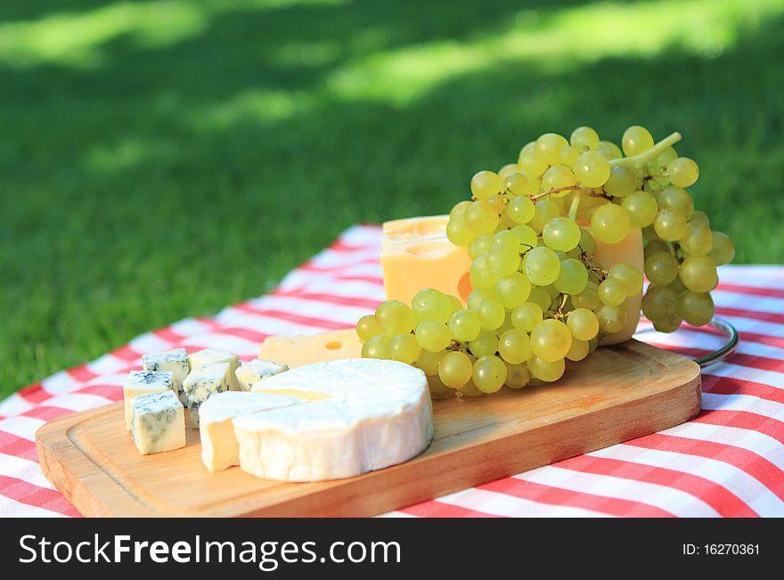 Various sorts of cheese with white grapes