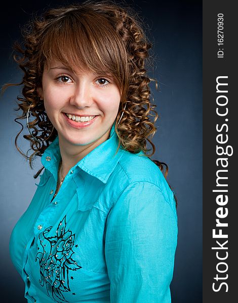 A happy young woman with big smile on dark background