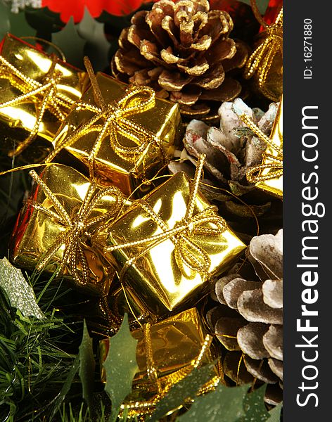 A close up shot of golden gift decorations with pine cones. A close up shot of golden gift decorations with pine cones
