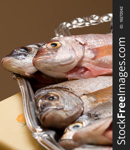 Fresh and cleaned sea fish on the plate, for seafood,fishing or  healthy eating themes. Fresh and cleaned sea fish on the plate, for seafood,fishing or  healthy eating themes