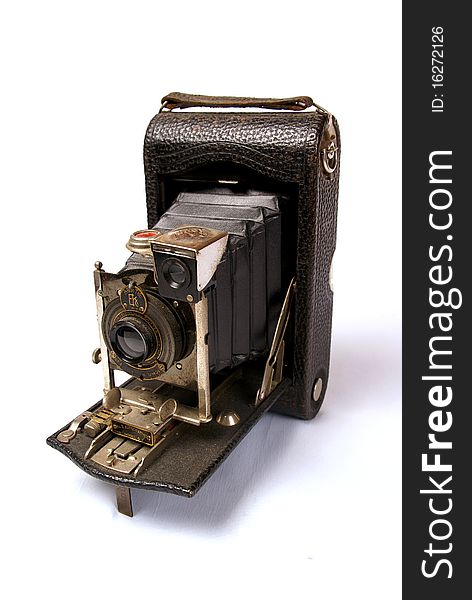 A close up shot of a vintage camera isolated on a white background. A close up shot of a vintage camera isolated on a white background