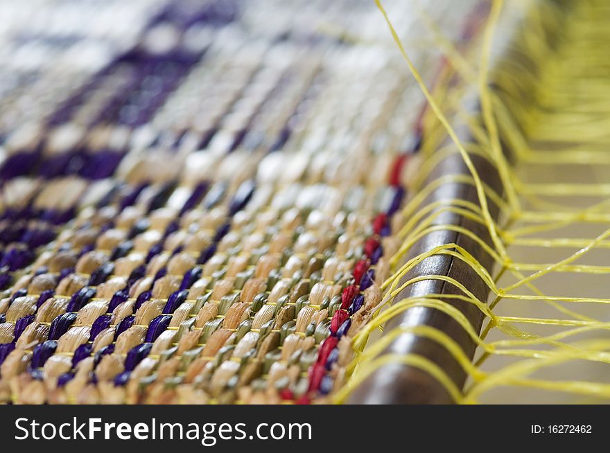 Detail of straw mat during production on a weave. Very shallow depth of field. Detail of straw mat during production on a weave. Very shallow depth of field.