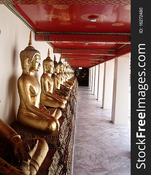 A picture taken of numerous Buddha's sitting in a line. A picture taken of numerous Buddha's sitting in a line.