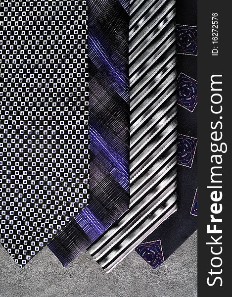 Four Ties With A Gray Background.