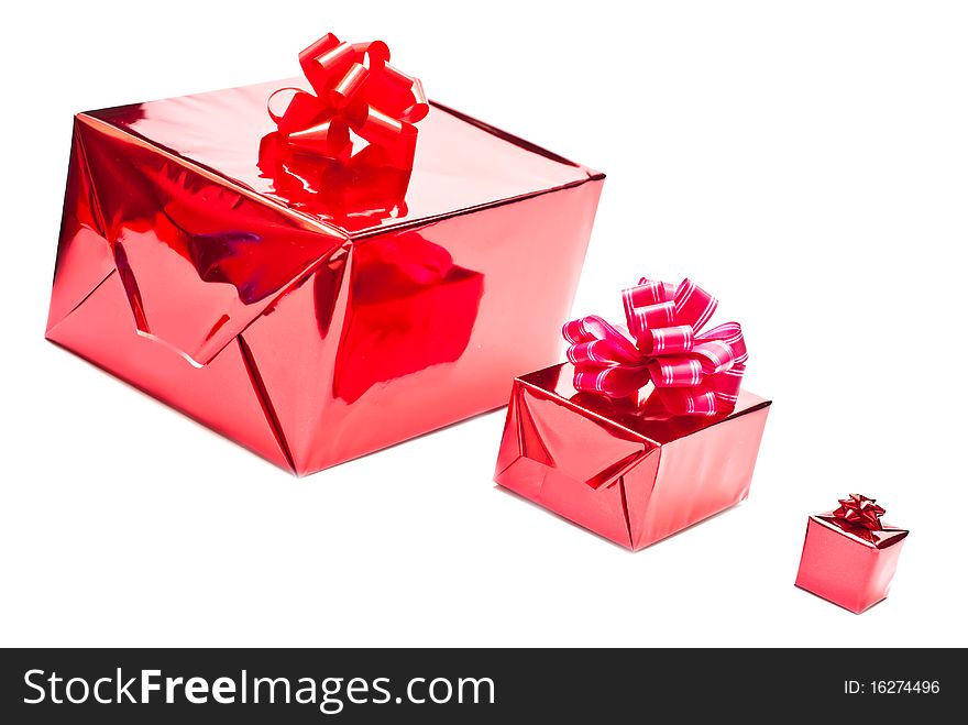 Row from red christmas gifts boxes with bows. Isolated on white background. Row from red christmas gifts boxes with bows. Isolated on white background