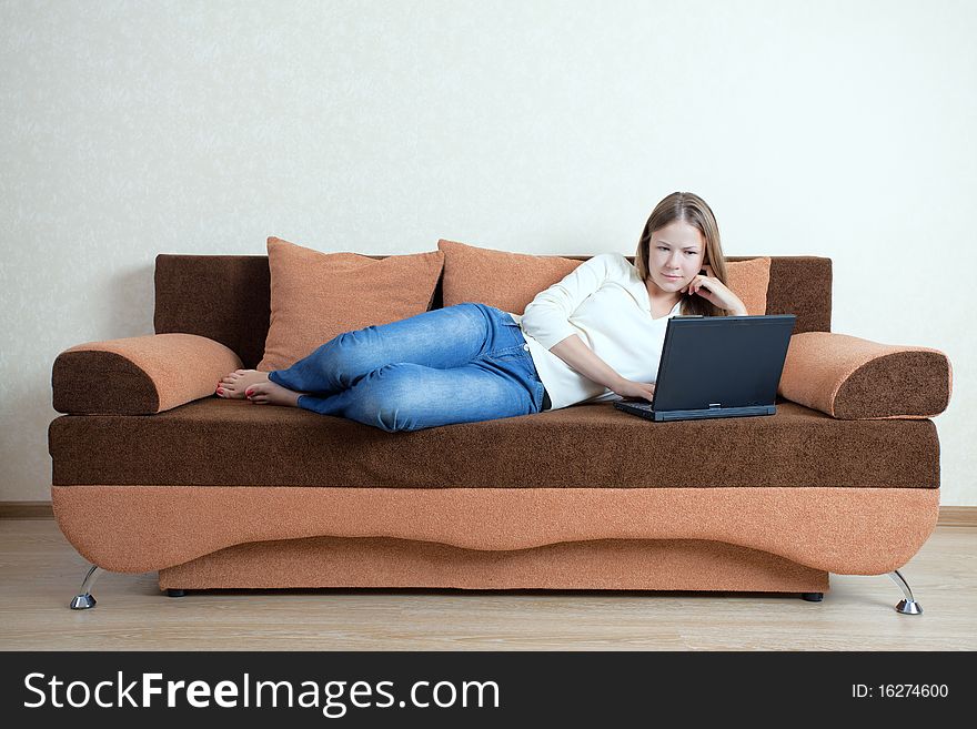 Woman With Laptop On The Sofa