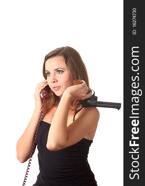 A young girl with revolver speak by phone on the white isolation background. A young girl with revolver speak by phone on the white isolation background