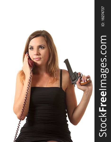 A young girl with revolver speak by phone on the white isolation background. A young girl with revolver speak by phone on the white isolation background