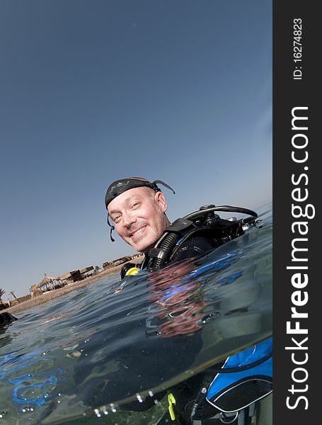 Male scuba diver smiles in anticipation of the dive. Male scuba diver smiles in anticipation of the dive