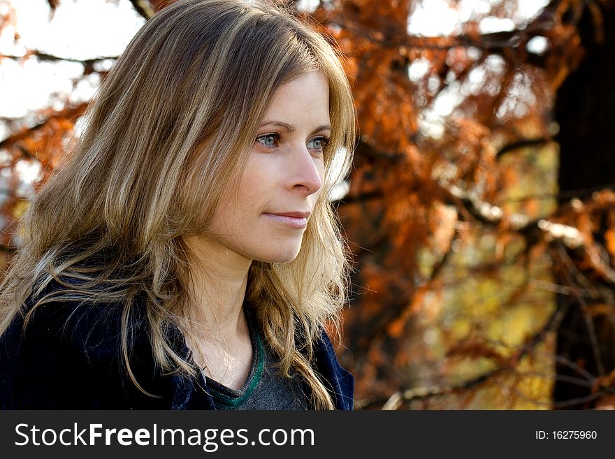 Blonde woman with blue eyes portrait outdoor in autumn. Blonde woman with blue eyes portrait outdoor in autumn