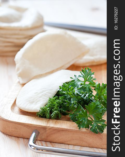 Pita bread over the cutting board. Pita bread over the cutting board