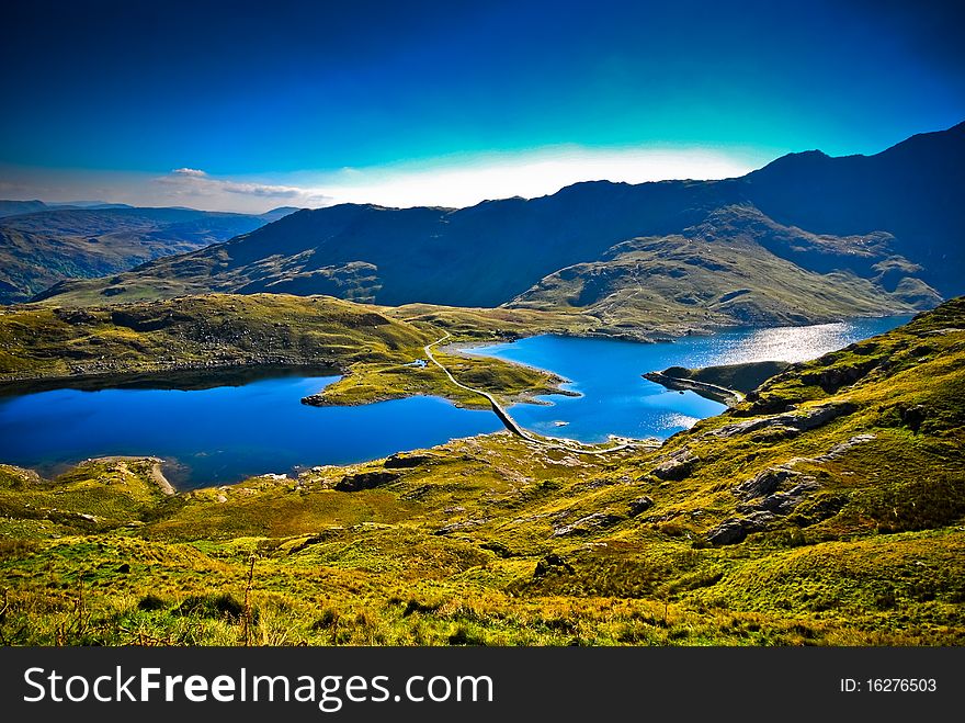 View of beautiful welsh mountain range with lake. View of beautiful welsh mountain range with lake
