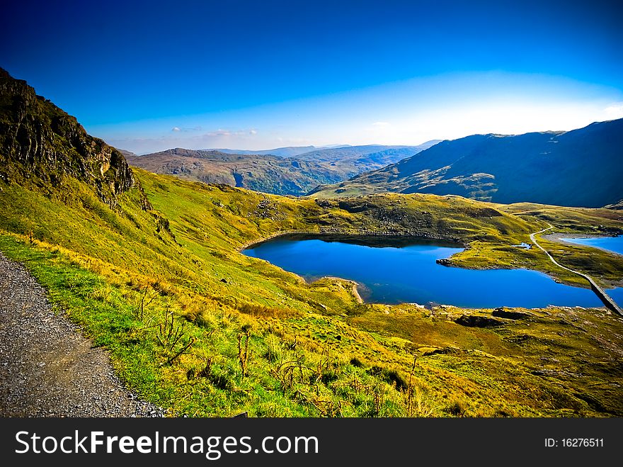 View of beautiful welsh mountain range with lake. View of beautiful welsh mountain range with lake