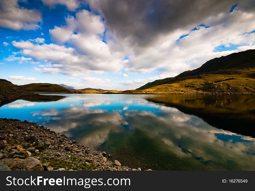 View of beautiful welsh mountain range with lake. View of beautiful welsh mountain range with lake