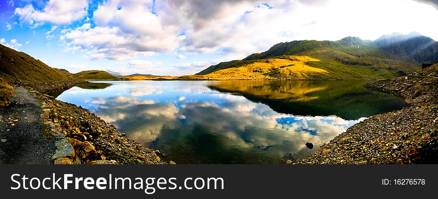View of beautiful welsh mountain range with reflection in the lake. View of beautiful welsh mountain range with reflection in the lake