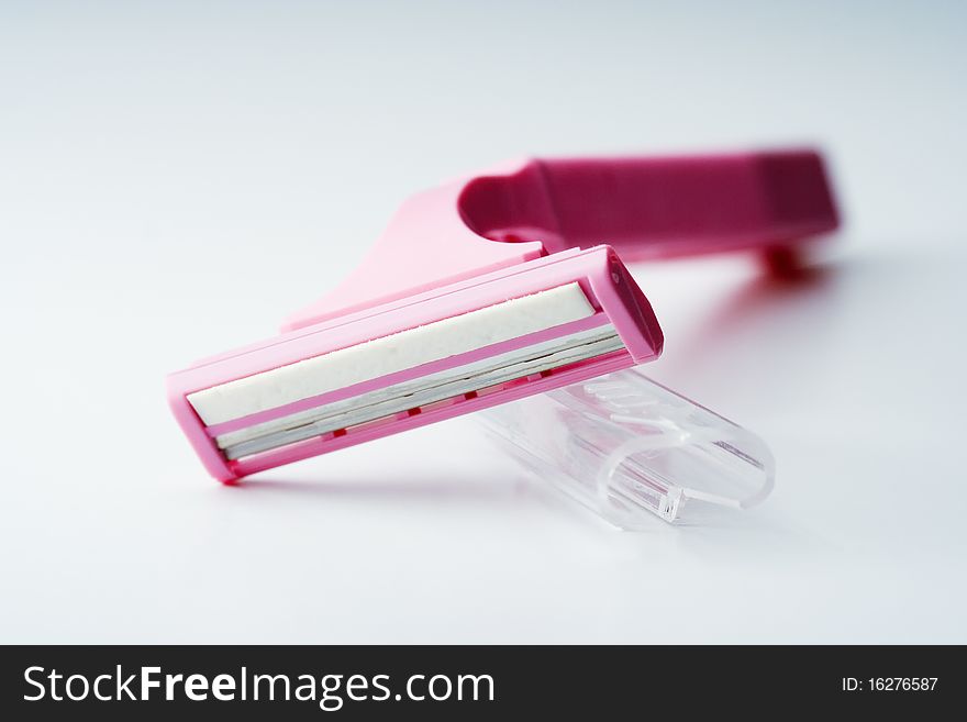 Image of pink razor isolated on white background.