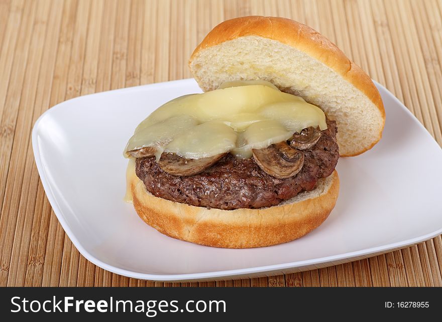 Mushroom burger with melted cheese on a plate