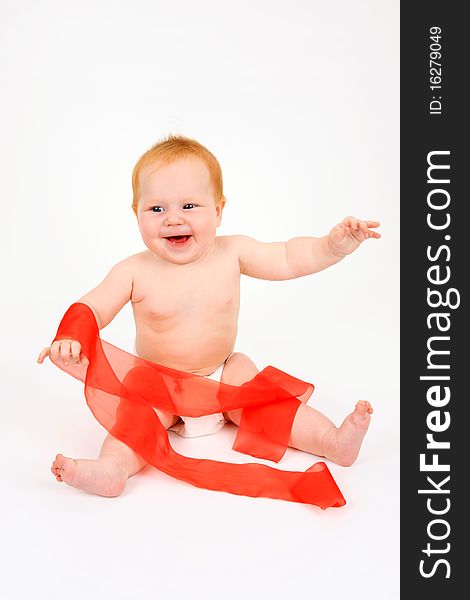 The child playing with a red ribbon on a white background