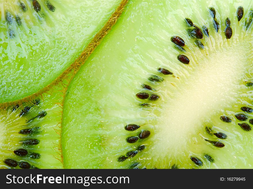 Macro of juicy green kiwi fruit slices