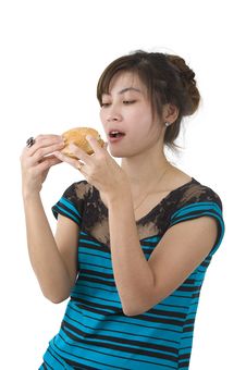 Young Woman Eating A Hamburger Royalty Free Stock Photography Young Woman Eating A Hamburger Royalty Free Stock Photography