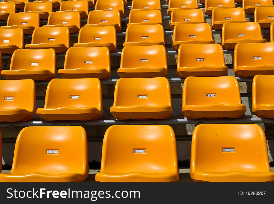 Rows of orange bright colour seat at the stadium unipue. Rows of orange bright colour seat at the stadium unipue.