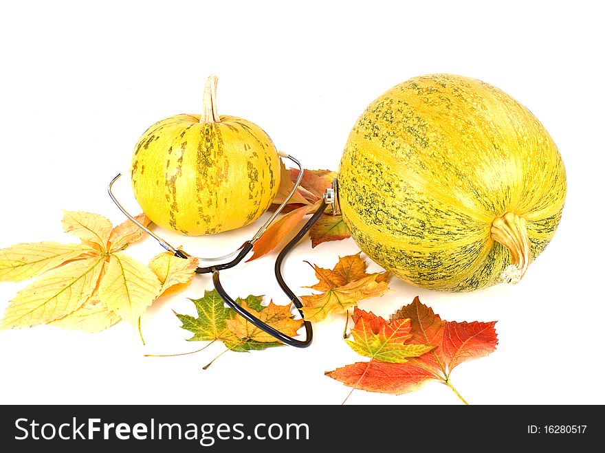 Two pumpkin and leafs with stethoscope