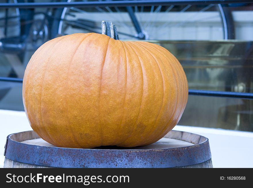 Isolated picture of a pumpkin sitting on a barrel