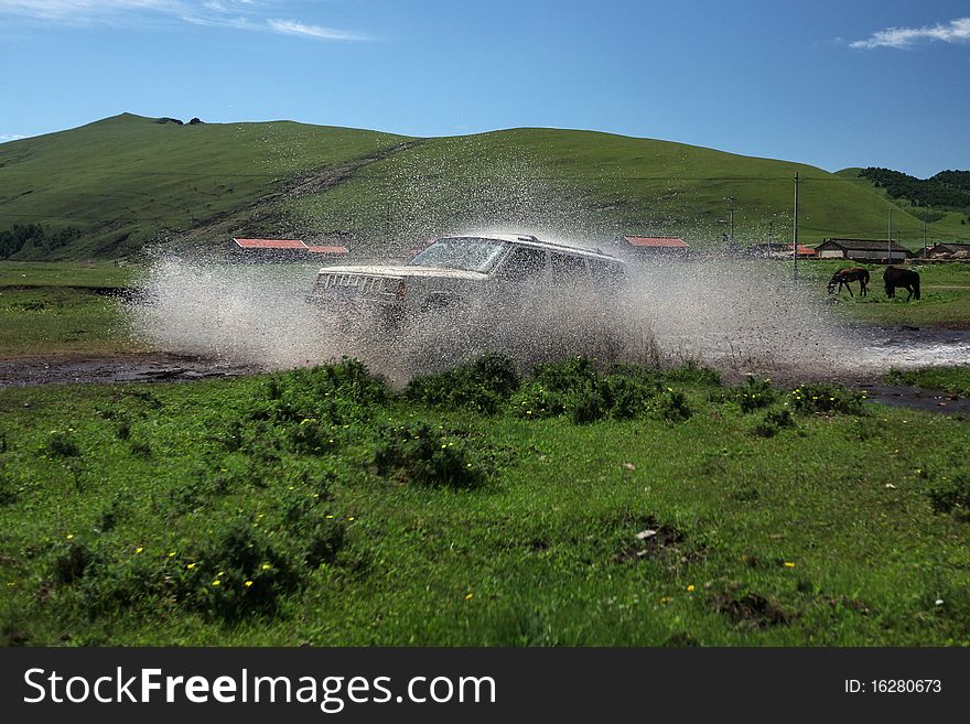 Vehicle at speed splashing out water. Vehicle at speed splashing out water