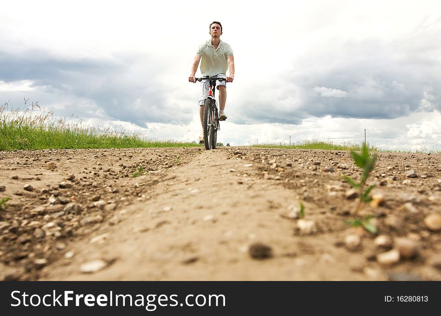 Man on bicycle, travels across the field
