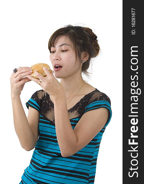 Pretty woman enjoying a hamburger over white background. Pretty woman enjoying a hamburger over white background