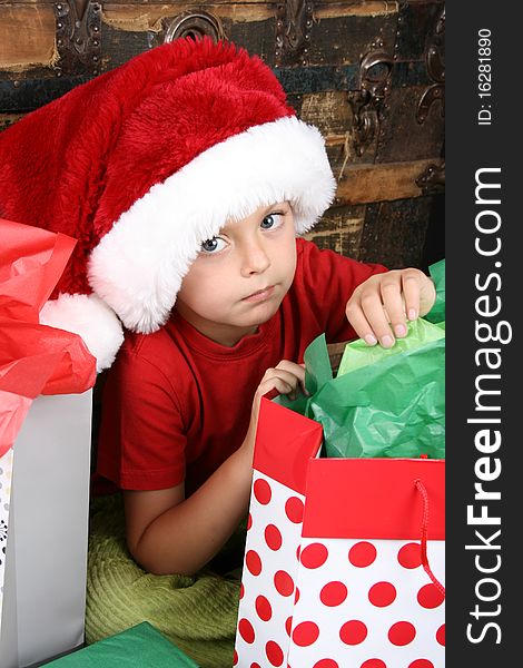 Little boy with big blue eyes wearing a christmas hat. Little boy with big blue eyes wearing a christmas hat