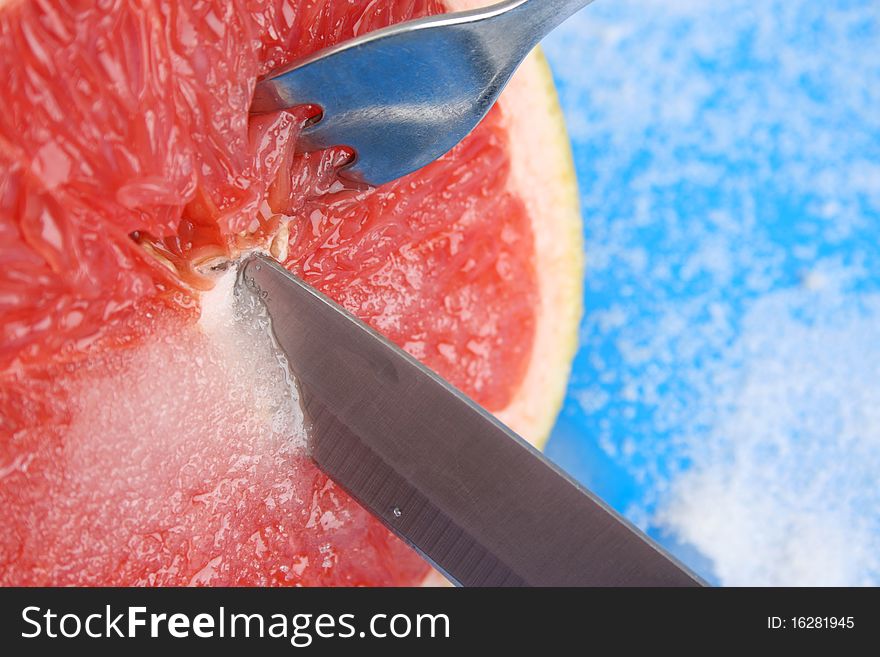 Red Pummelo on a blue background with sugar