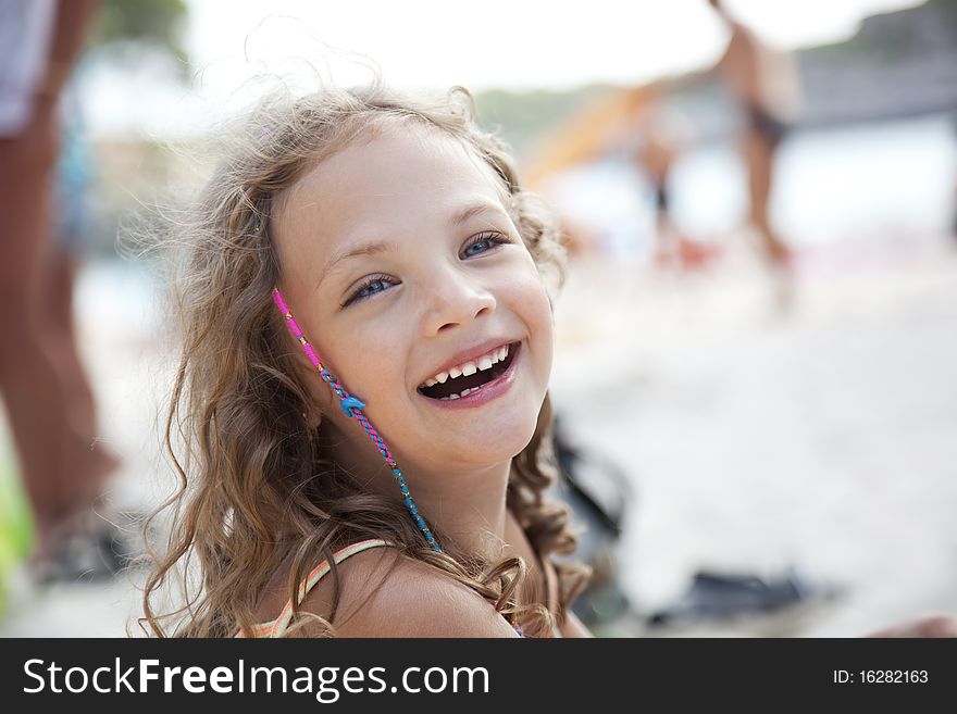 Portrait of a laughing little girl on a beach