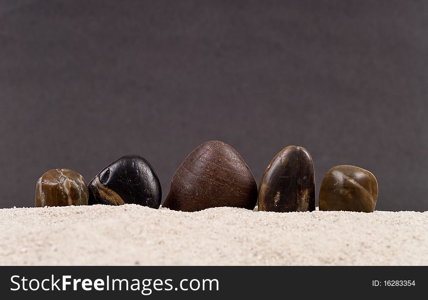 Smooth Stones Protruding From Sand. Smooth Stones Protruding From Sand