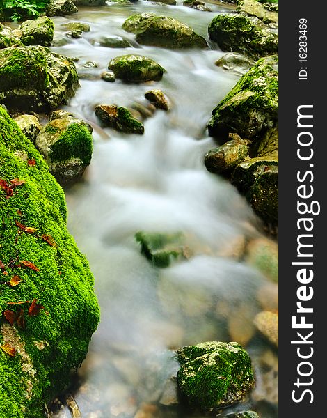 Beautiful fast river streaming between mossy stones. Beautiful fast river streaming between mossy stones