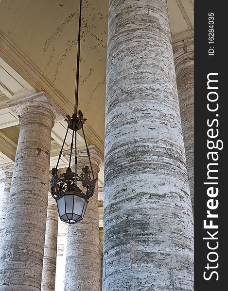 Some pillars and a chandelier at the st. peters square in rome. Some pillars and a chandelier at the st. peters square in rome