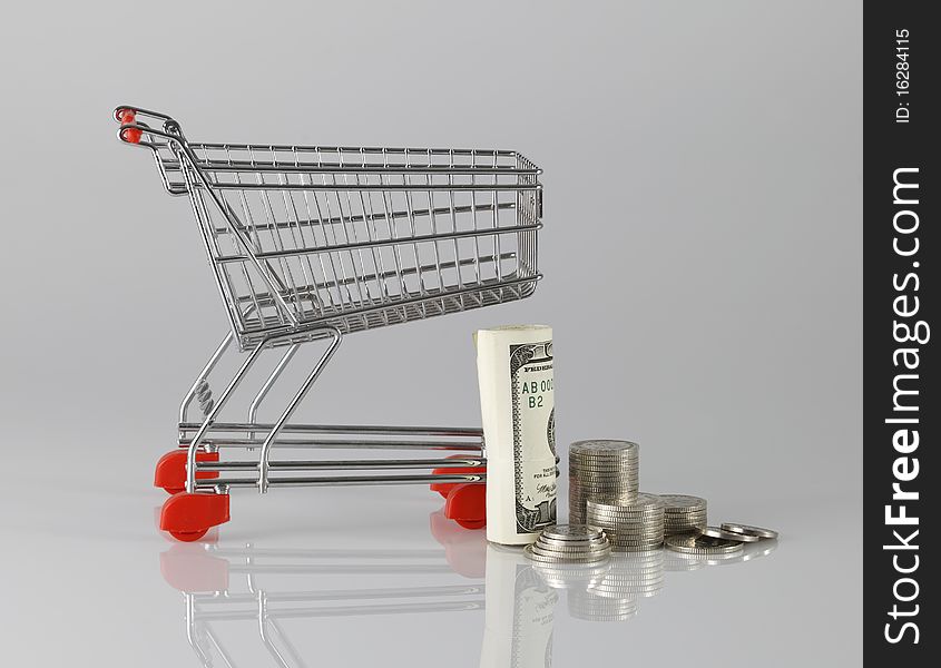 Shopping wagon cart with paper money and coin. Shopping wagon cart with paper money and coin