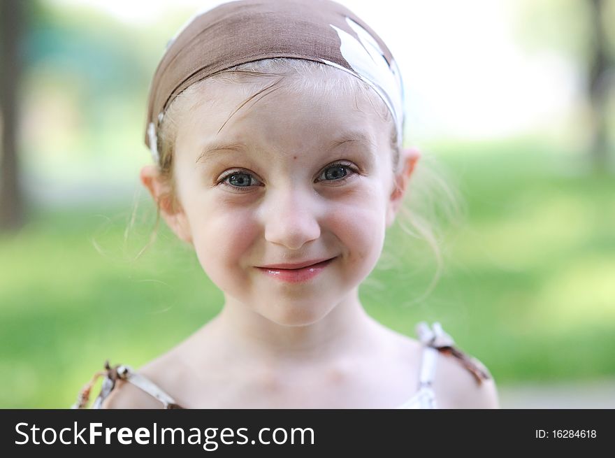 Adorable 4 years girl smiles and looks into the camera