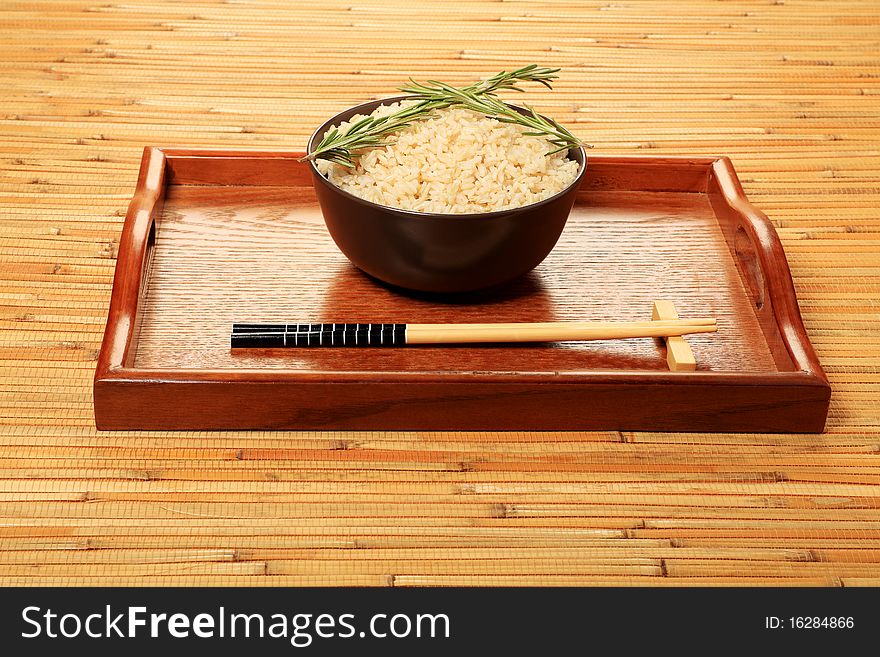 Steamed long rice in a brown bowl with chopsticks. Steamed long rice in a brown bowl with chopsticks.