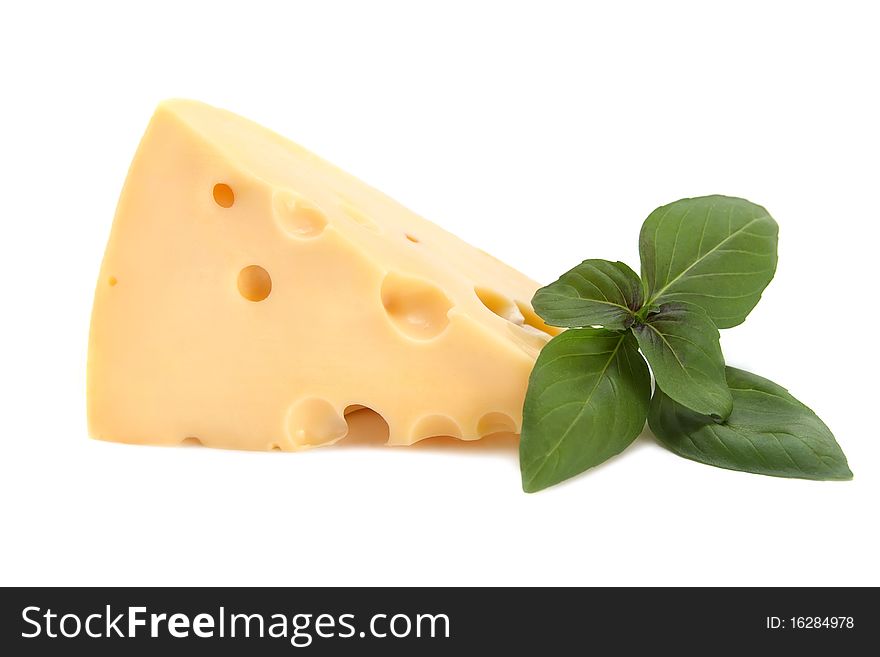 Piece of fresh delicious cheese with basil isolated on white background