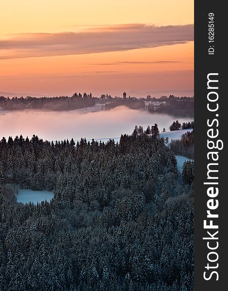 Winter sunrise scene with trees and outlook tower in the background. Winter sunrise scene with trees and outlook tower in the background.