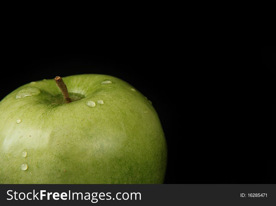 Delicious fresh green apple isolated on black