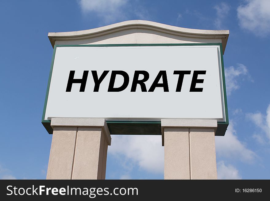 The word 'hydrate' on an elegant sign against a blue sky.