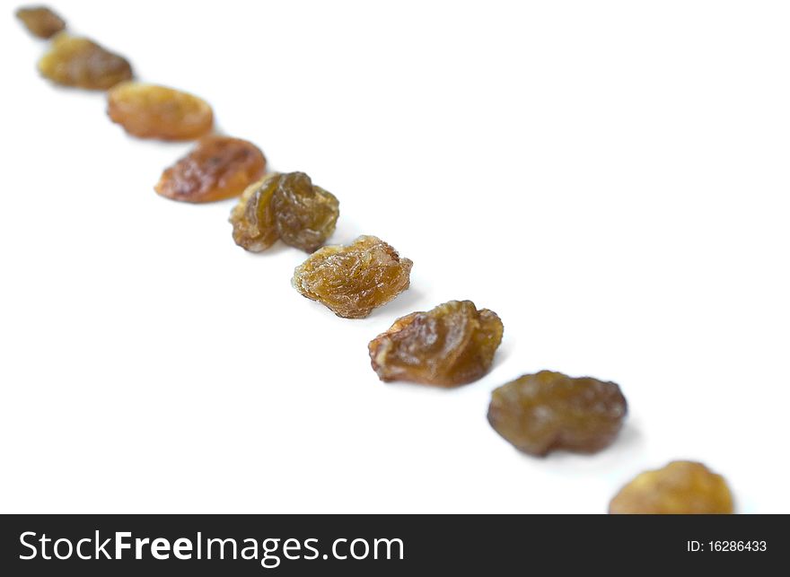 Line of raisins isolated over white background