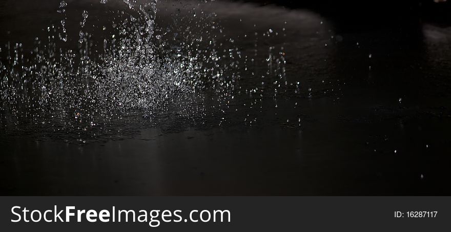 Water frozen in air as it hits the ground. Water frozen in air as it hits the ground